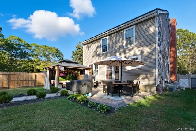 a front view of a house with a yard table and chairs
