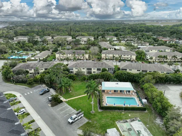 an aerial view of a house with garden space and lake view