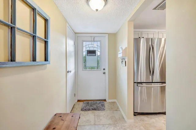 a view of a hallway with wooden floor and a cabinet