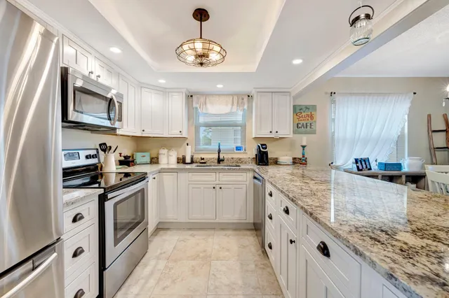 a kitchen with stainless steel appliances granite countertop a sink and stove top oven