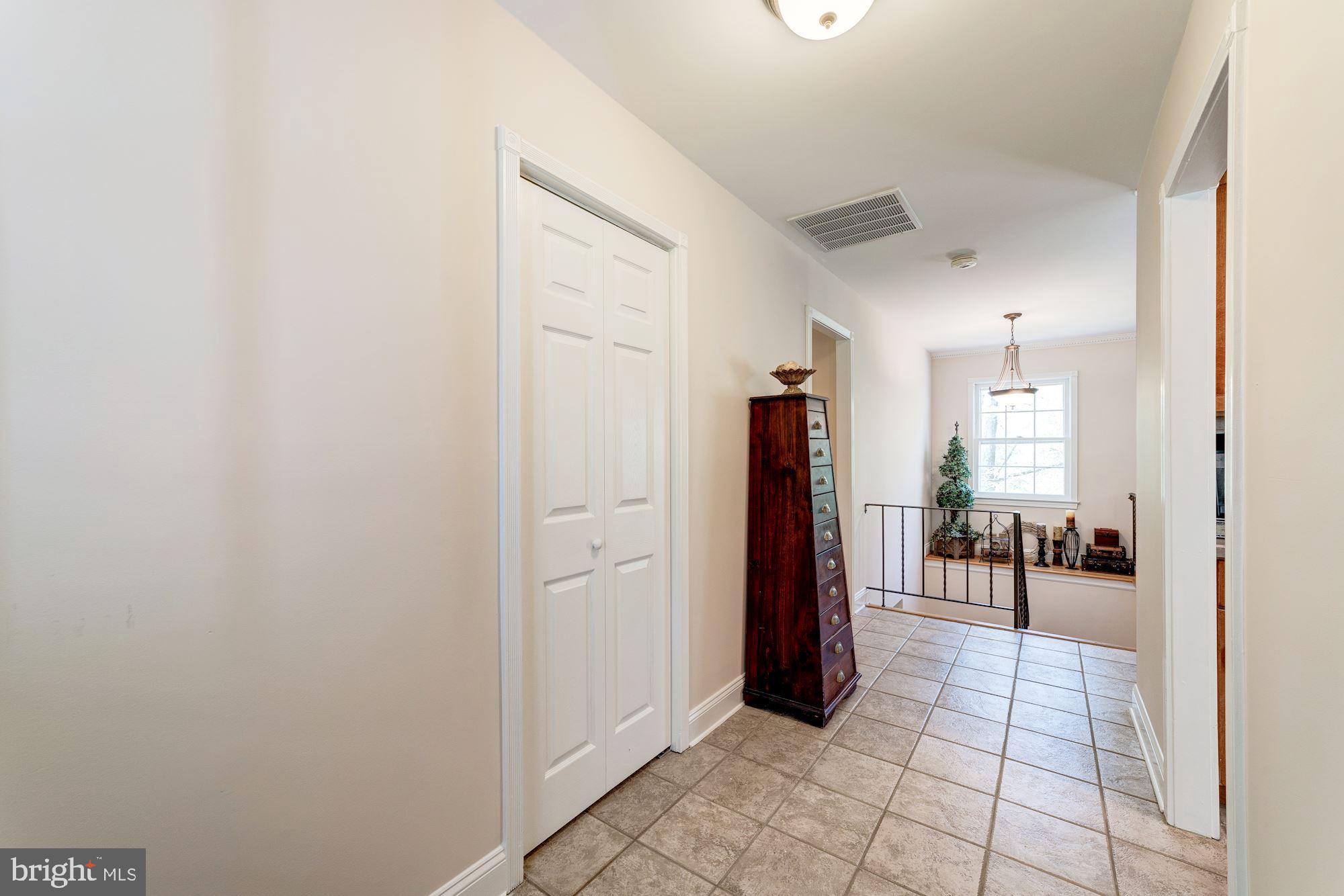 11310 Myrtle Lane Reston, VA 20191 - Photo 12 of 42 a view of a hallway with a furniture and a living room