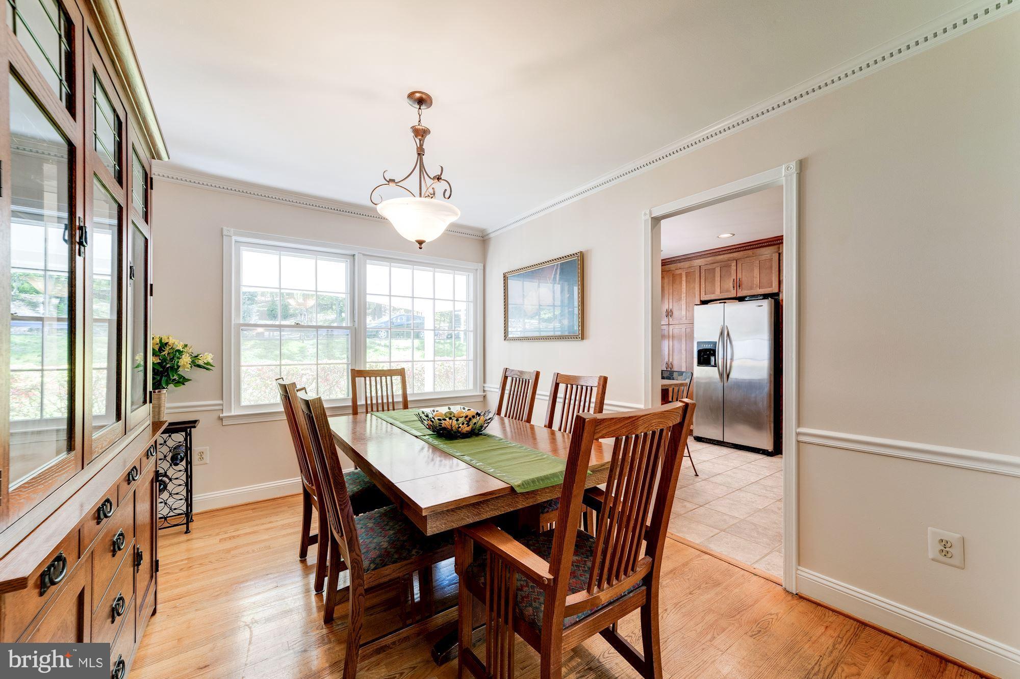 11310 Myrtle Lane Reston, VA 20191 - Photo 14 of 42 a view of a dining room with furniture window and wooden floor