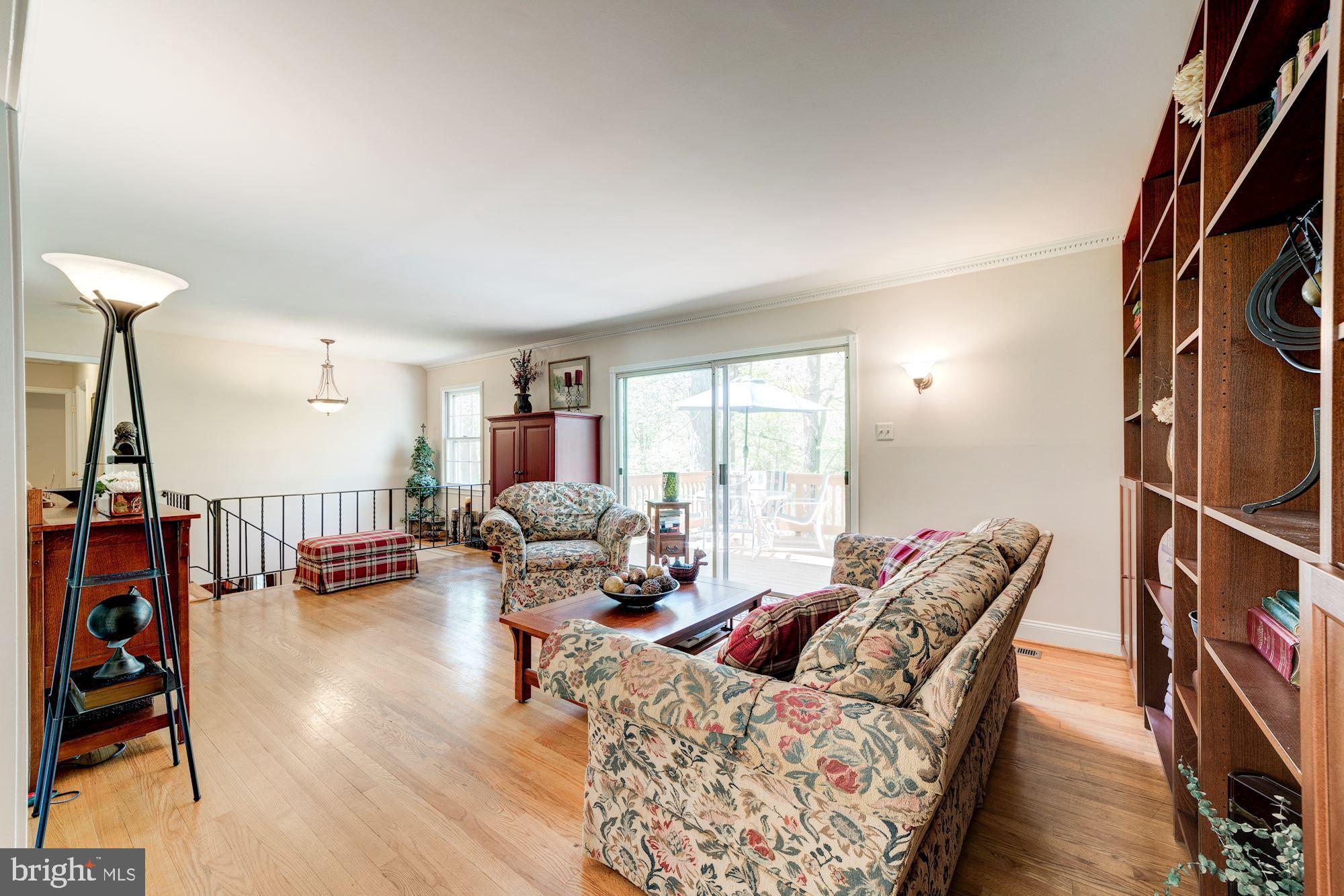 11310 Myrtle Lane Reston, VA 20191 - Photo 16 of 42 a living room with furniture and a flat screen tv with wooden floor