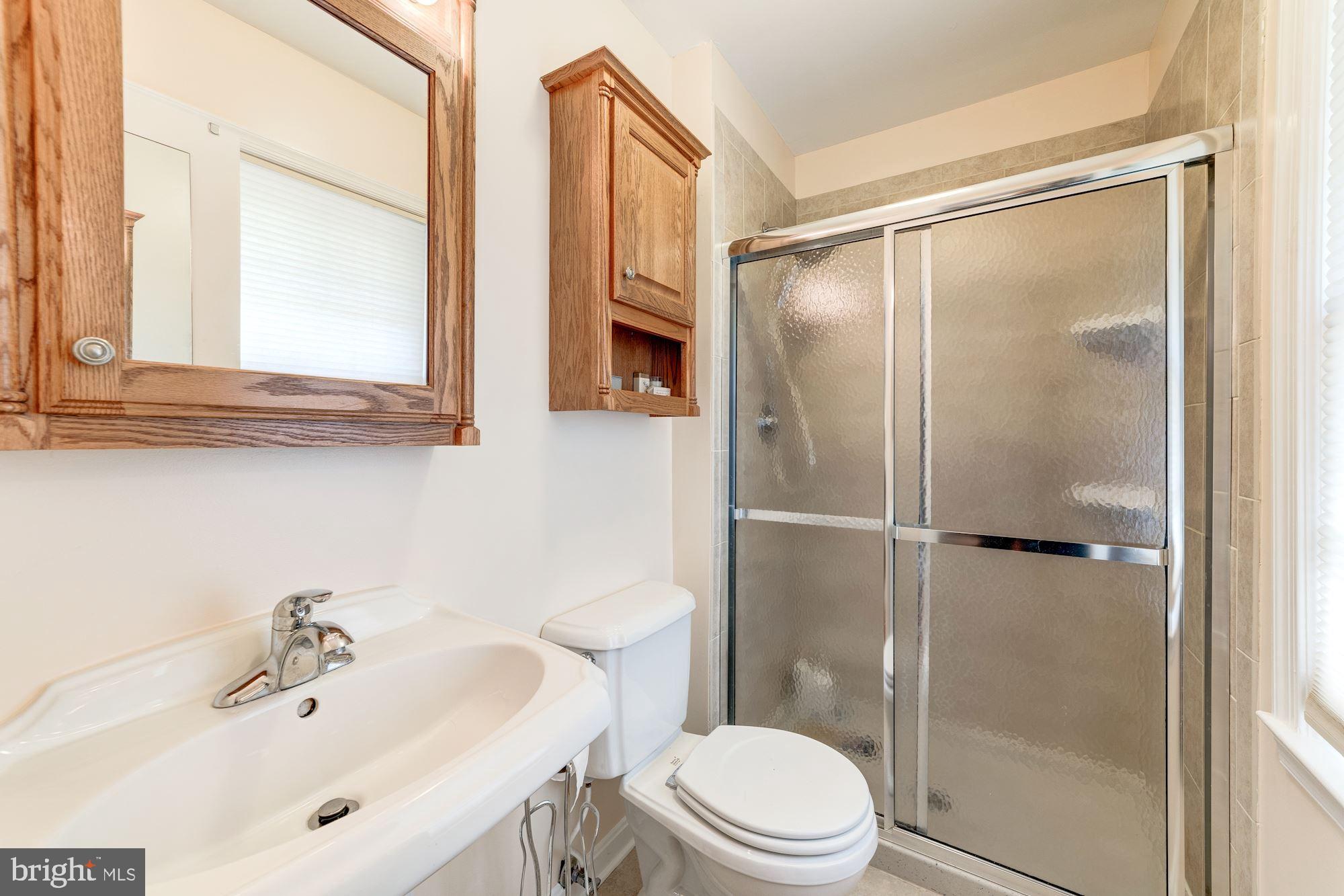11310 Myrtle Lane Reston, VA 20191 - Photo 21 of 42 a bathroom with a shower sink vanity mirror and toilet