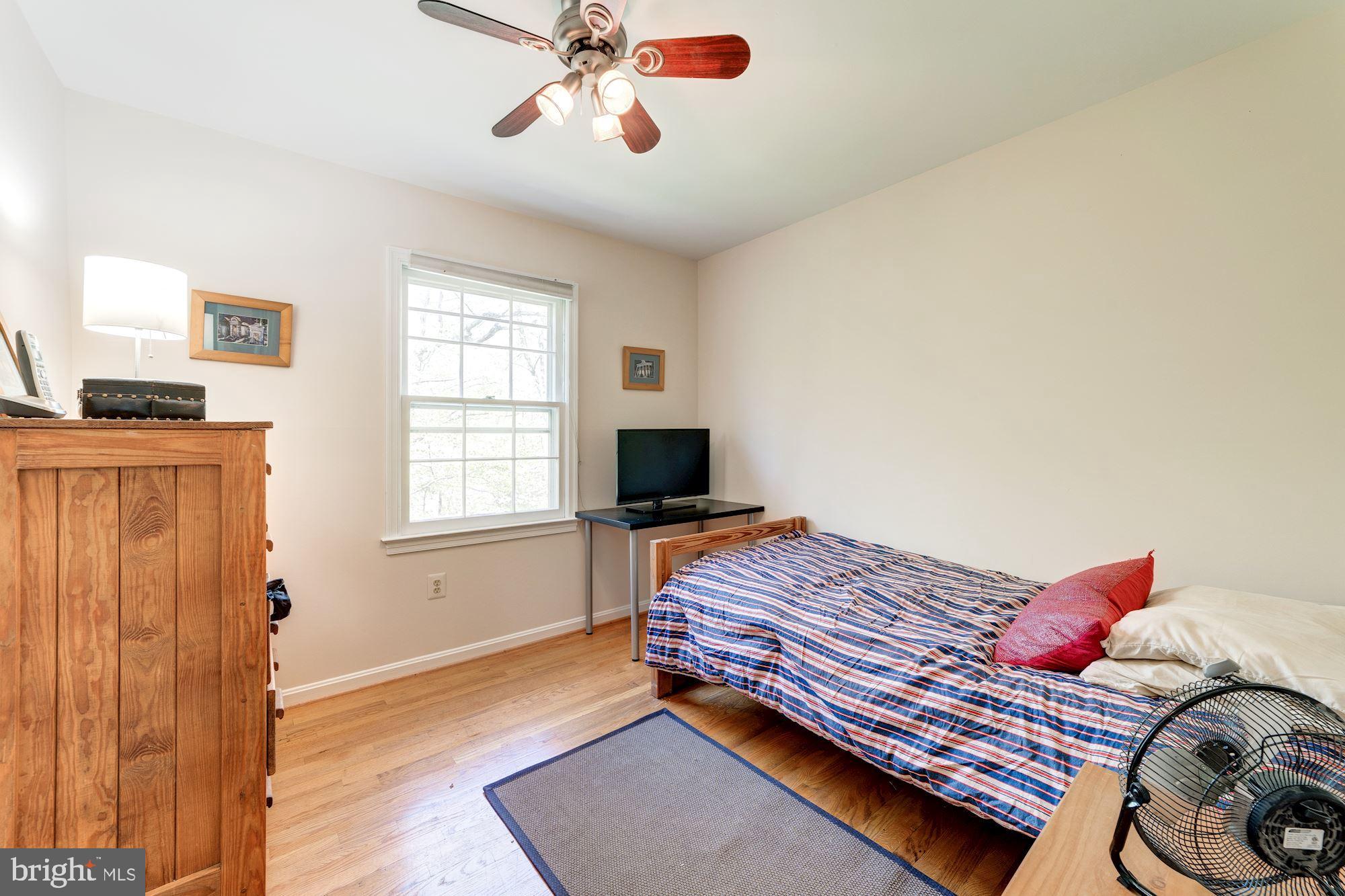 11310 Myrtle Lane Reston, VA 20191 - Photo 23 of 42 a bedroom with a bed and wooden floor