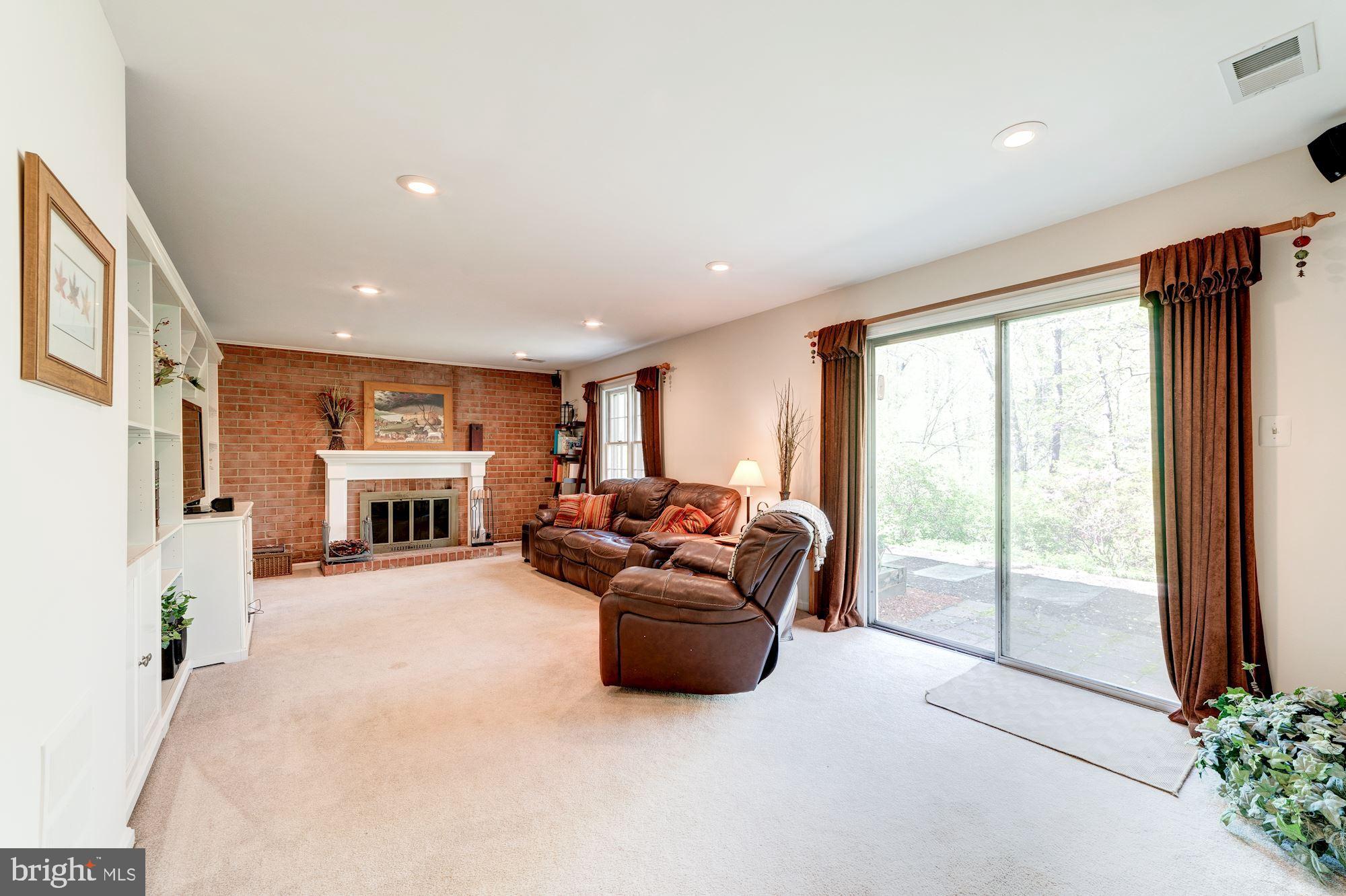 11310 Myrtle Lane Reston, VA 20191 - Photo 26 of 42 a living room with furniture and a floor to ceiling window