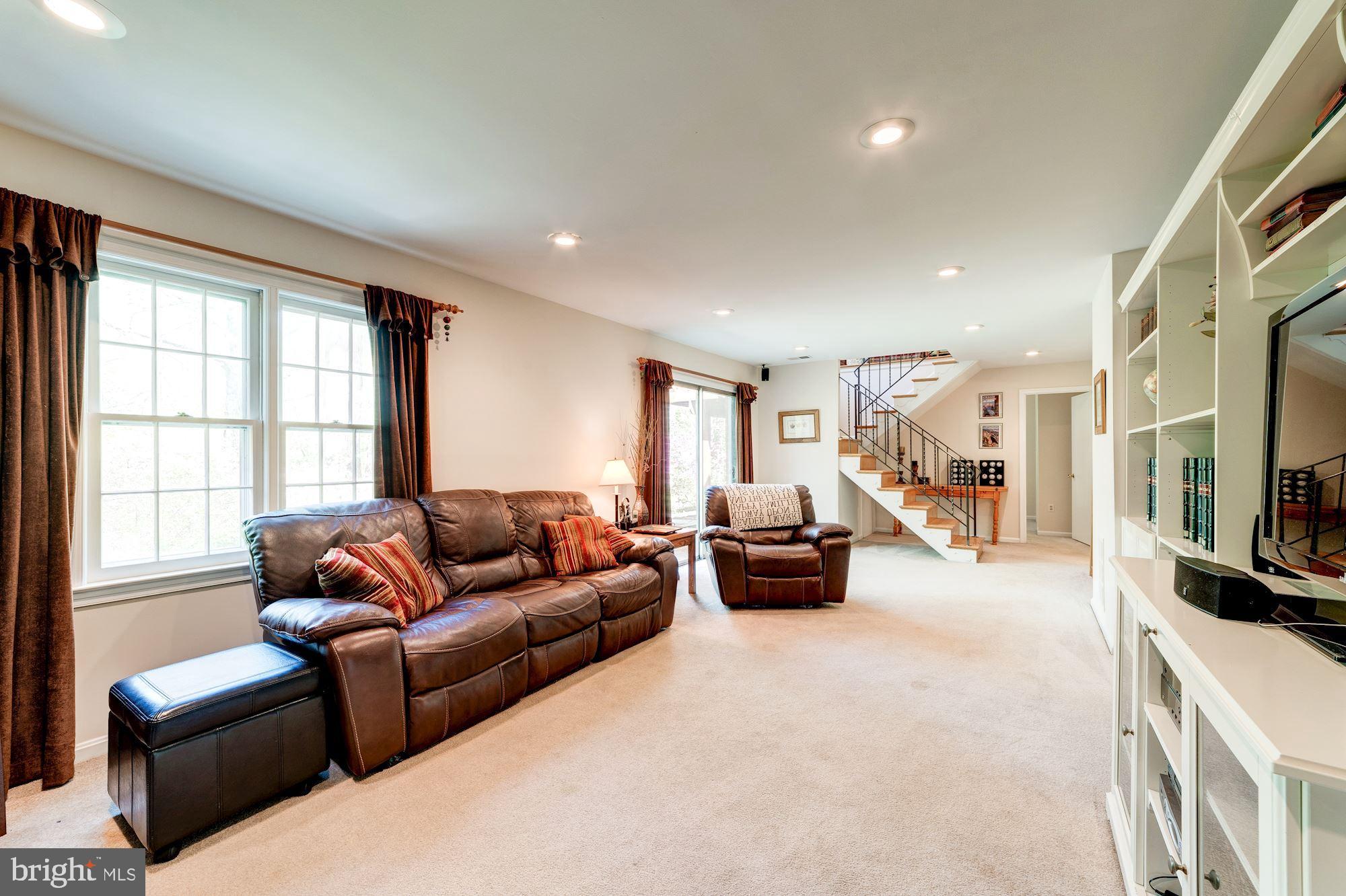 11310 Myrtle Lane Reston, VA 20191 - Photo 29 of 42 a living room with furniture and a flat screen tv