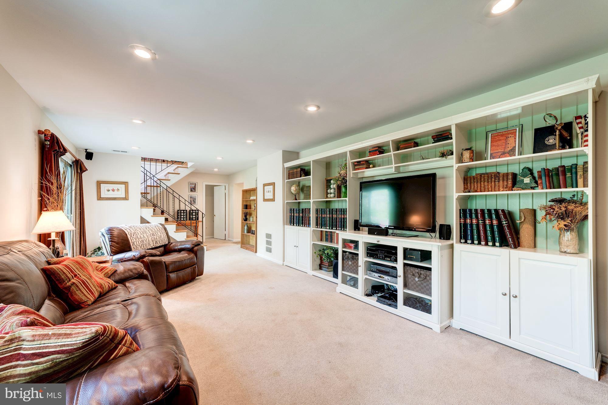 11310 Myrtle Lane Reston, VA 20191 - Photo 30 of 42 a living room with furniture and a flat screen tv