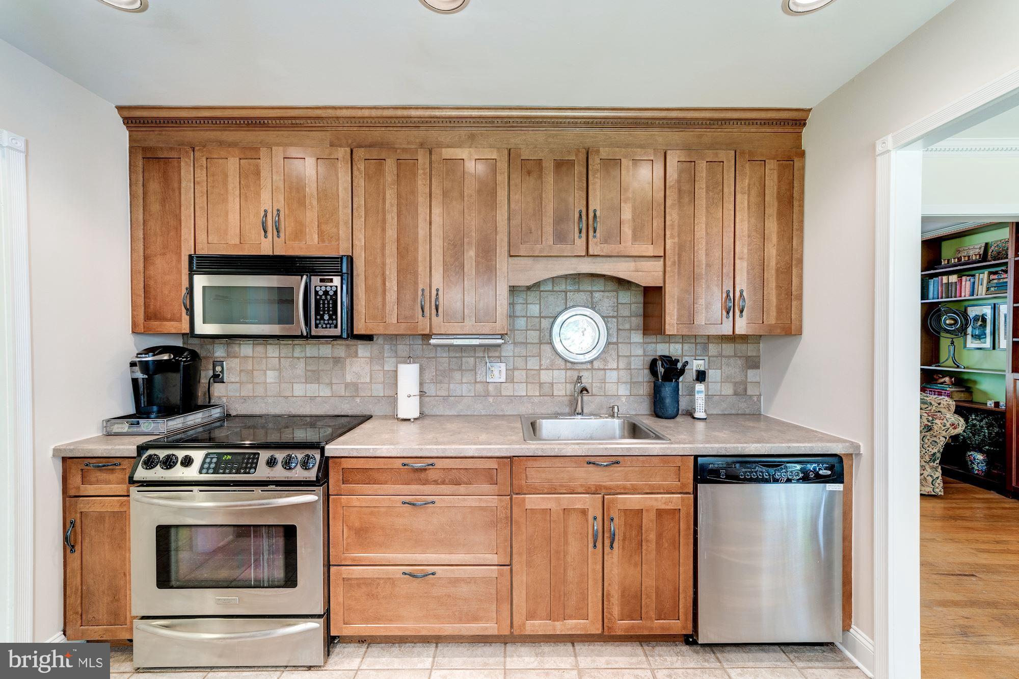 11310 Myrtle Lane Reston, VA 20191 - Photo 4 of 42 a kitchen with stainless steel appliances a stove a sink and a microwave