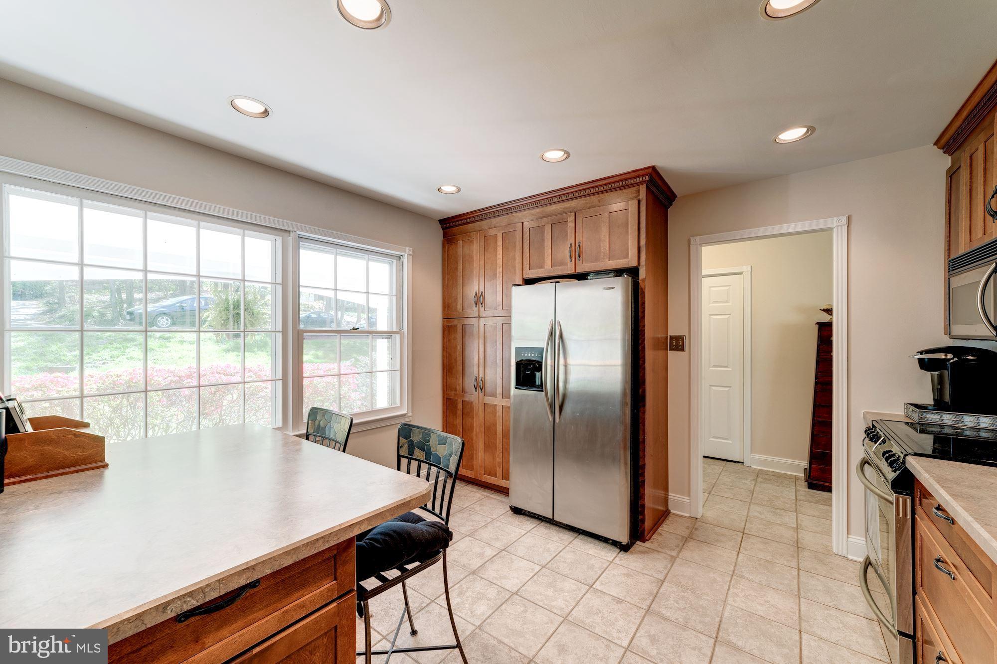 11310 Myrtle Lane Reston, VA 20191 - Photo 7 of 42 a kitchen with stainless steel appliances a refrigerator and a stove top oven