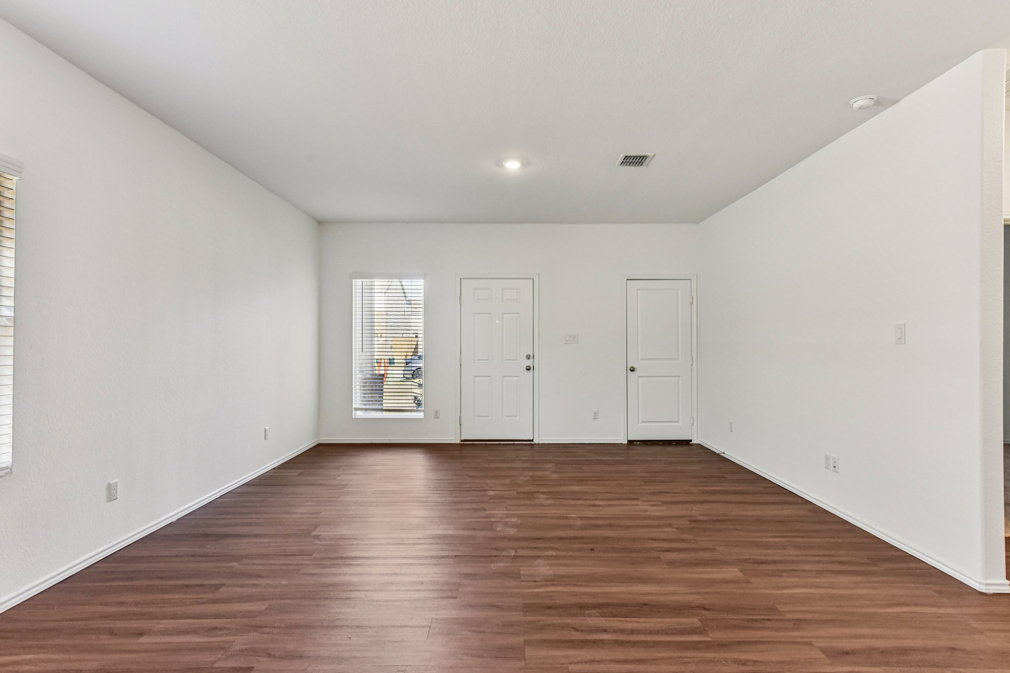 312 The Bad Way Jarrell, TX 76537 - Photo 11 of 38 a view of an empty room with wooden floor
