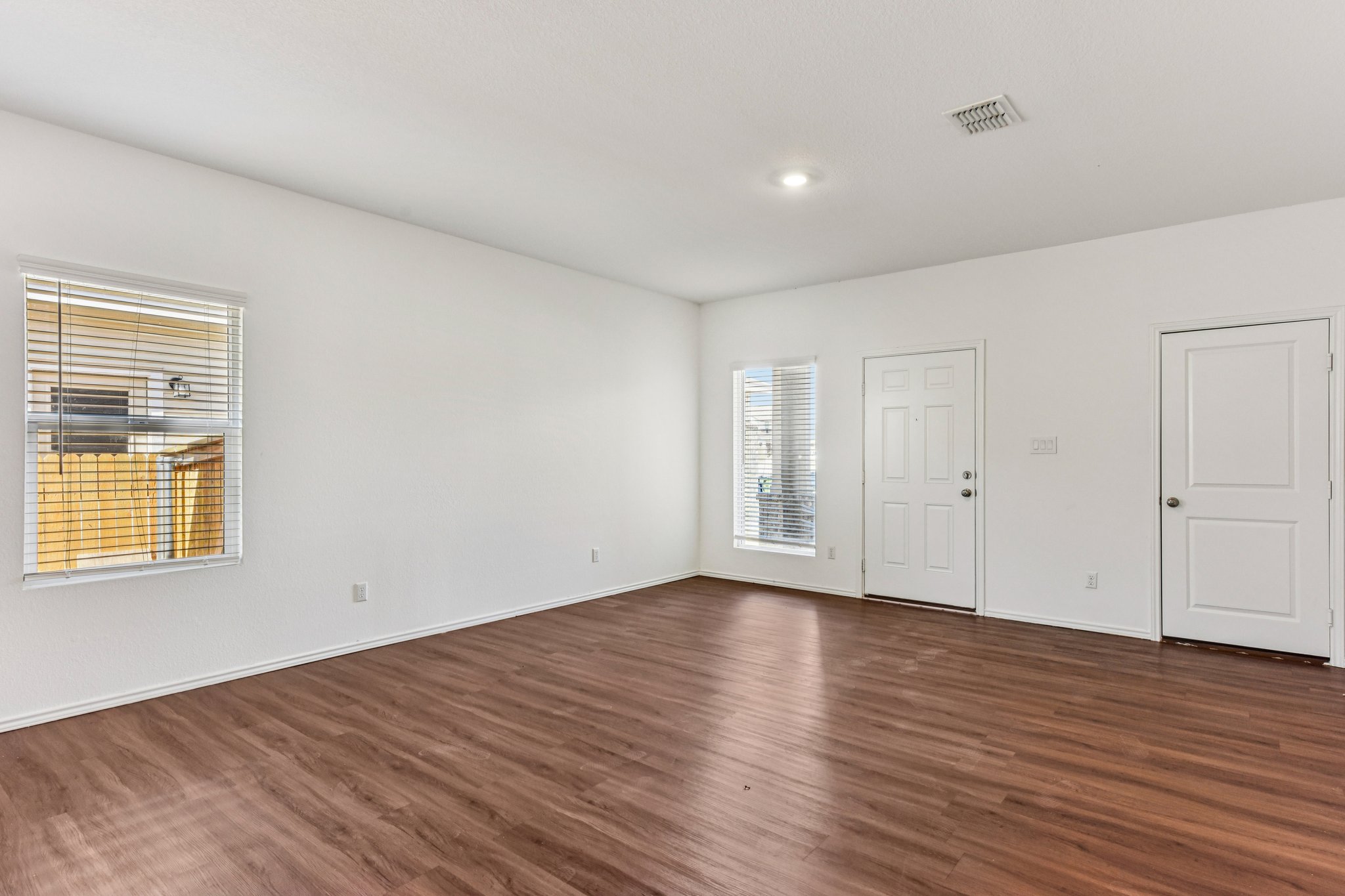 312 The Bad Way Jarrell, TX 76537 - Photo 12 of 38 a view of an empty room with wooden floor and a window