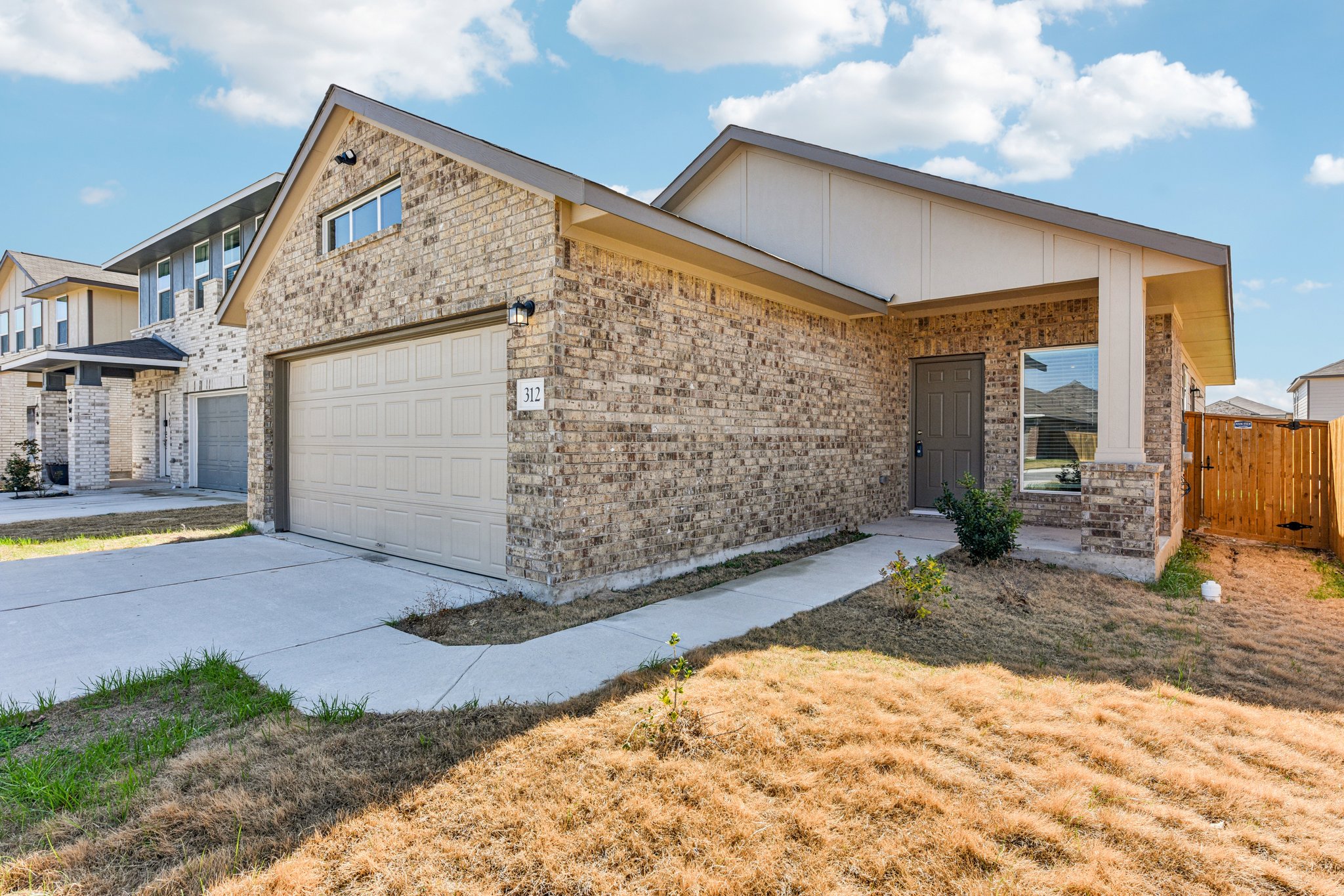 312 The Bad Way Jarrell, TX 76537 - Photo 2 of 38 a front view of a house with garden
