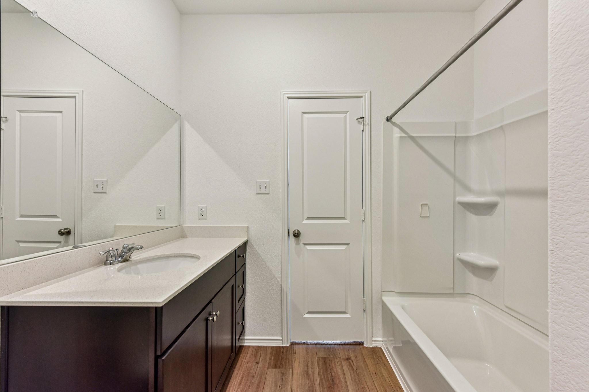 312 The Bad Way Jarrell, TX 76537 - Photo 26 of 38 a bathroom with a sink a mirror and a bathtub