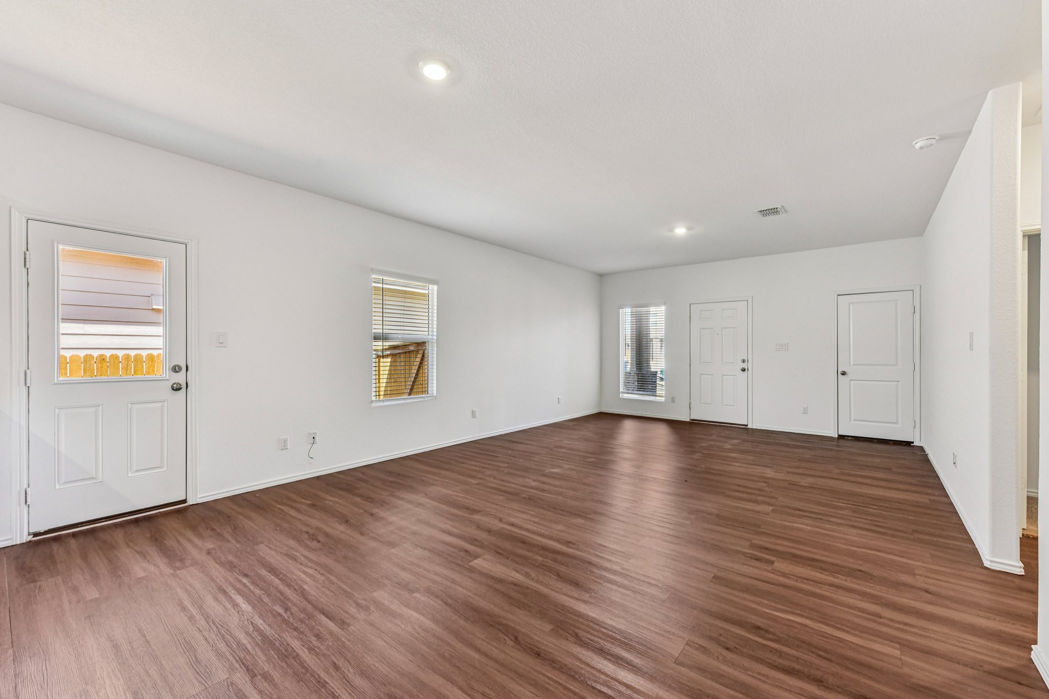 312 The Bad Way Jarrell, TX 76537 - Photo 3 of 38 an empty room with wooden floor and window