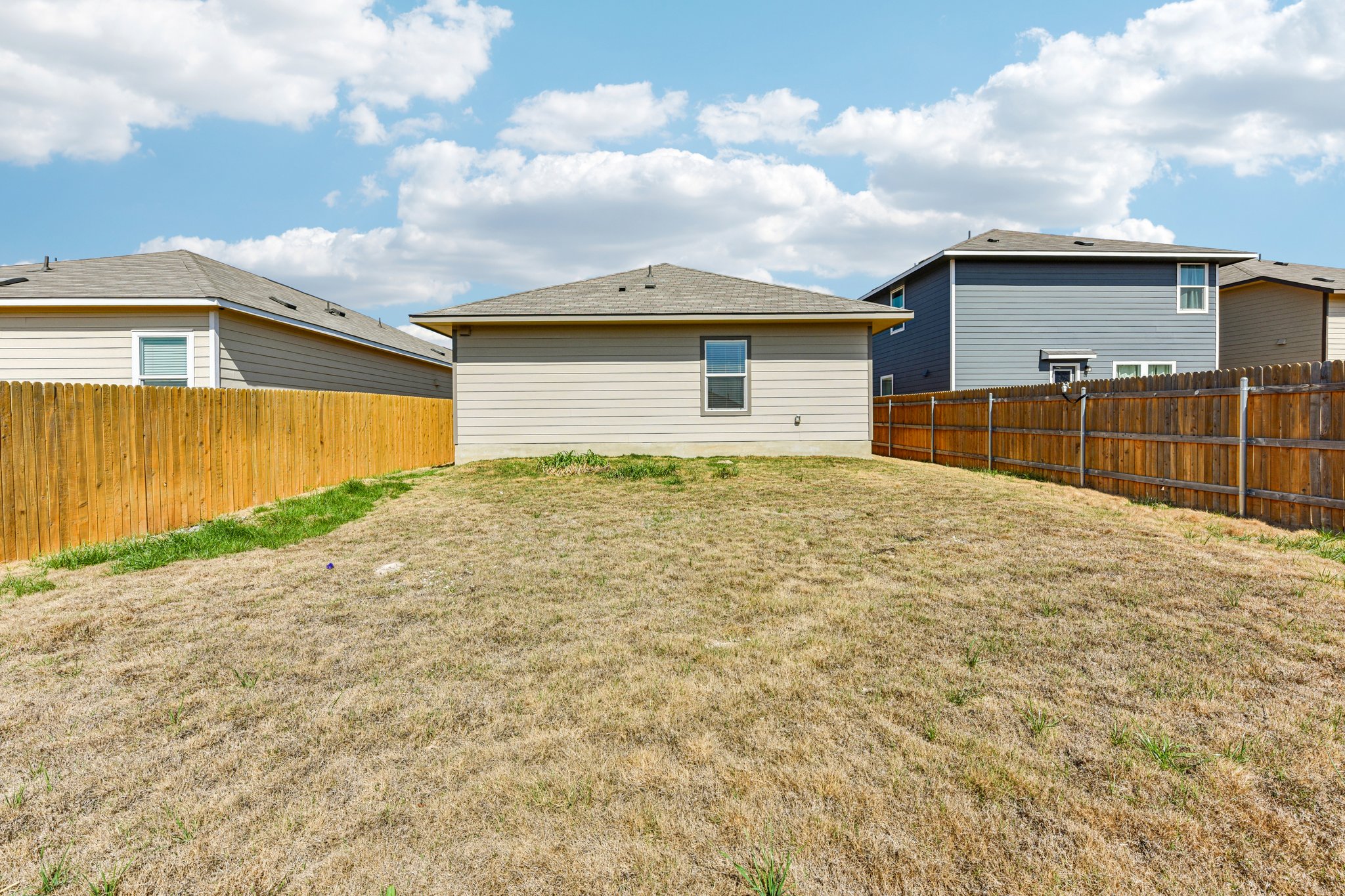 312 The Bad Way Jarrell, TX 76537 - Photo 35 of 38 a front view of a house with a yard and garage