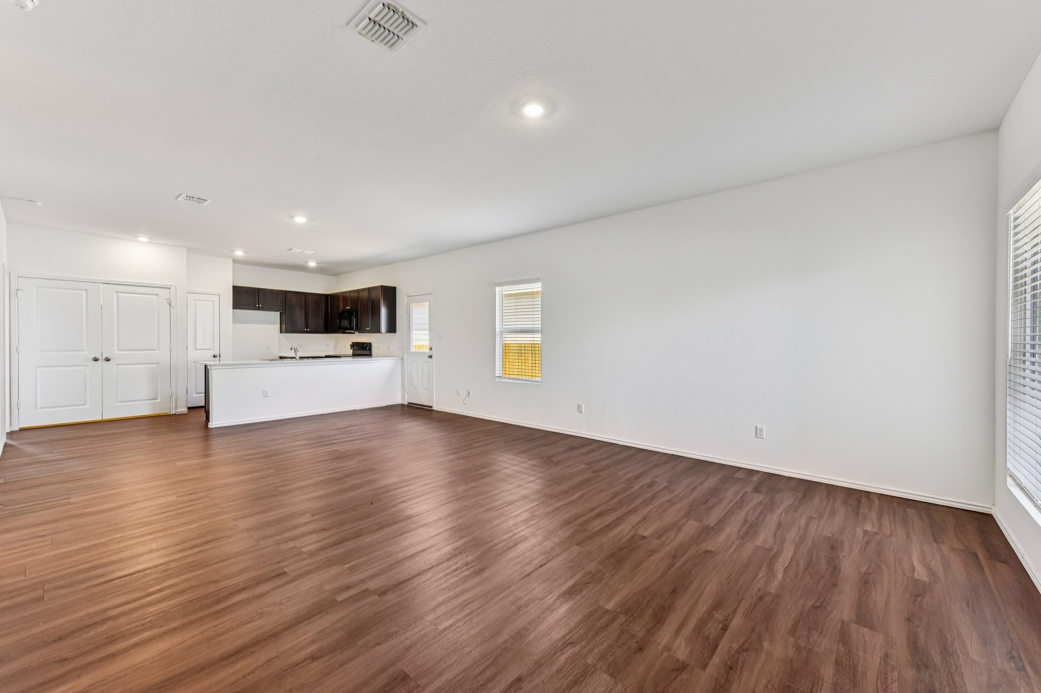 312 The Bad Way Jarrell, TX 76537 - Photo 4 of 38 a view of a kitchen with a microwave and a stove top oven