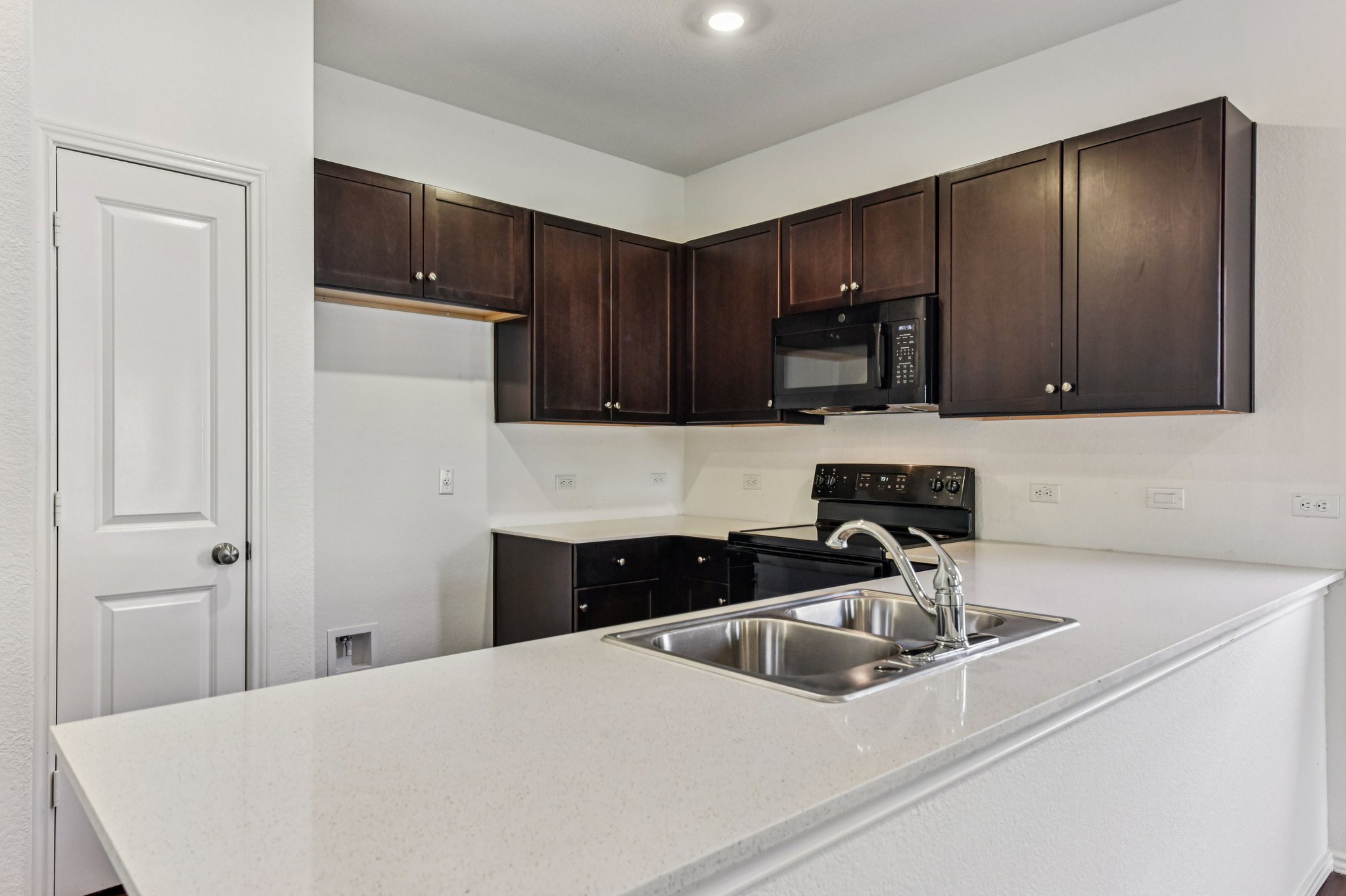 312 The Bad Way Jarrell, TX 76537 - Photo 7 of 38 a kitchen with a sink a stove and refrigerator