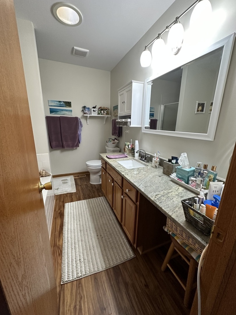 308 Glenbrook Trail McHenry, IL 60050 - Photo 17 of 29 a kitchen with a sink dishwasher and a stove with wooden floor
