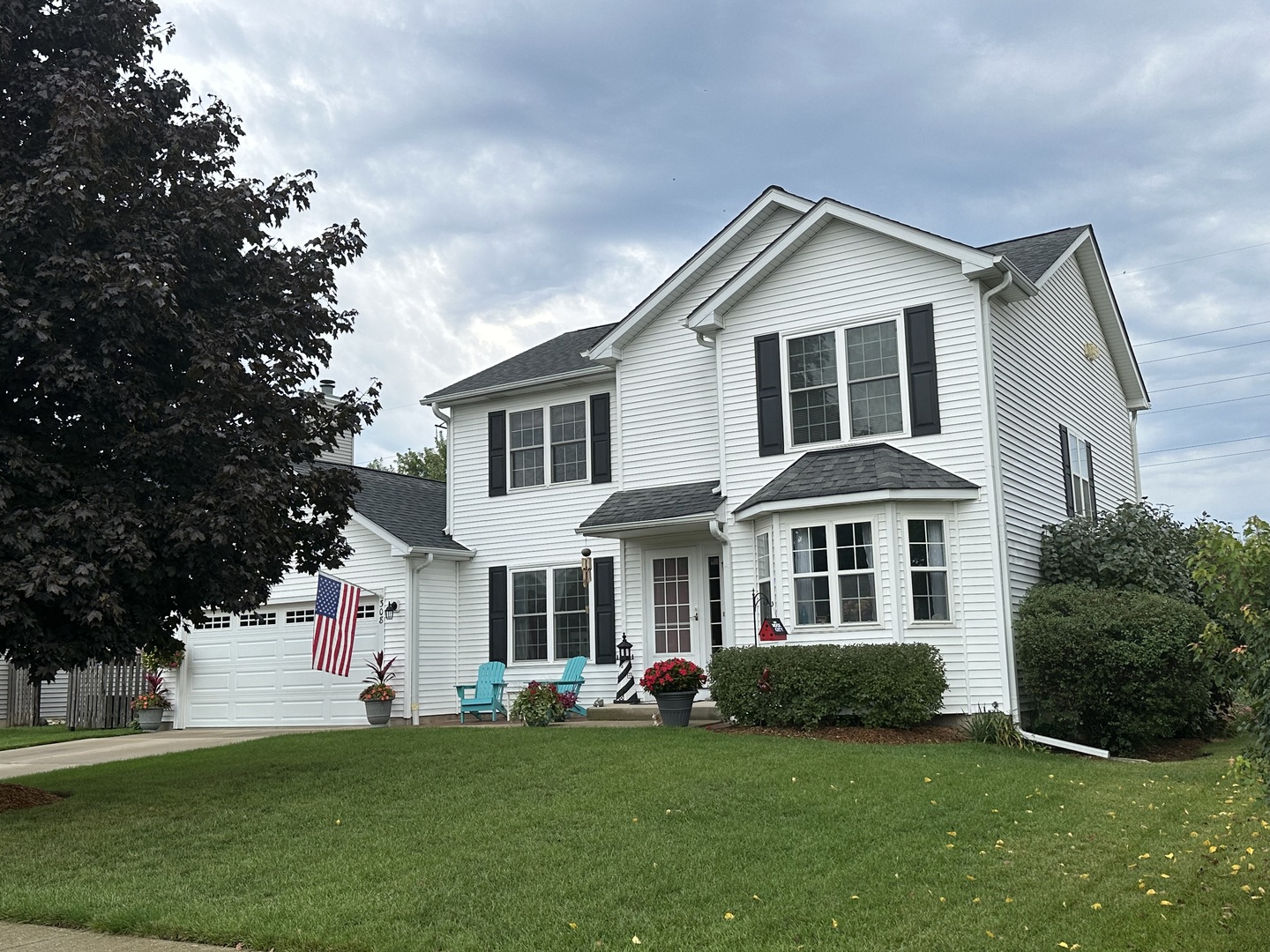 308 Glenbrook Trail McHenry, IL 60050 - Photo 2 of 29 a front view of a house with a garden