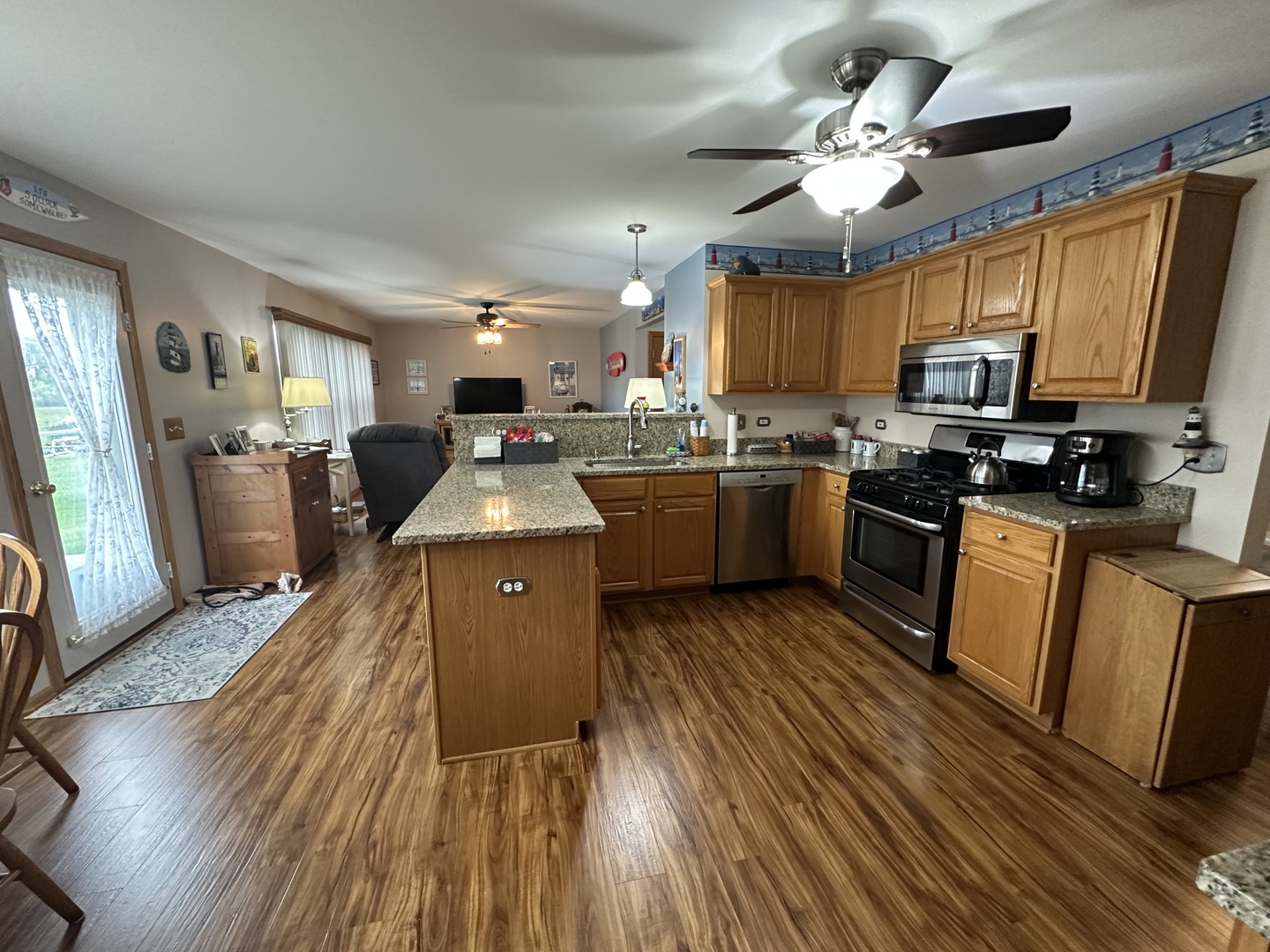308 Glenbrook Trail McHenry, IL 60050 - Photo 5 of 29 a kitchen with stainless steel appliances granite countertop wooden floors stove top oven and refrigerator