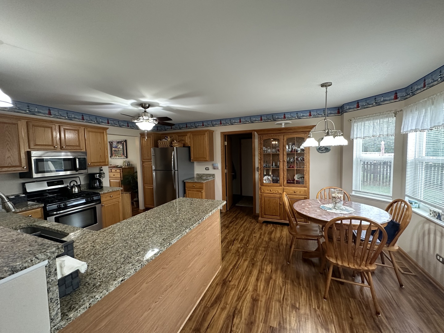 308 Glenbrook Trail McHenry, IL 60050 - Photo 7 of 29 a kitchen with stainless steel appliances kitchen island granite countertop a sink and cabinets