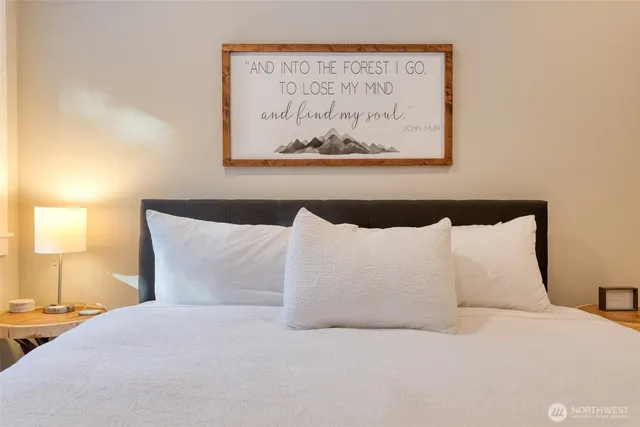 a large bed sitting in a bedroom next to a window