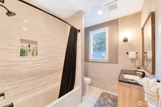 a bathroom with a sink a mirror and a shower