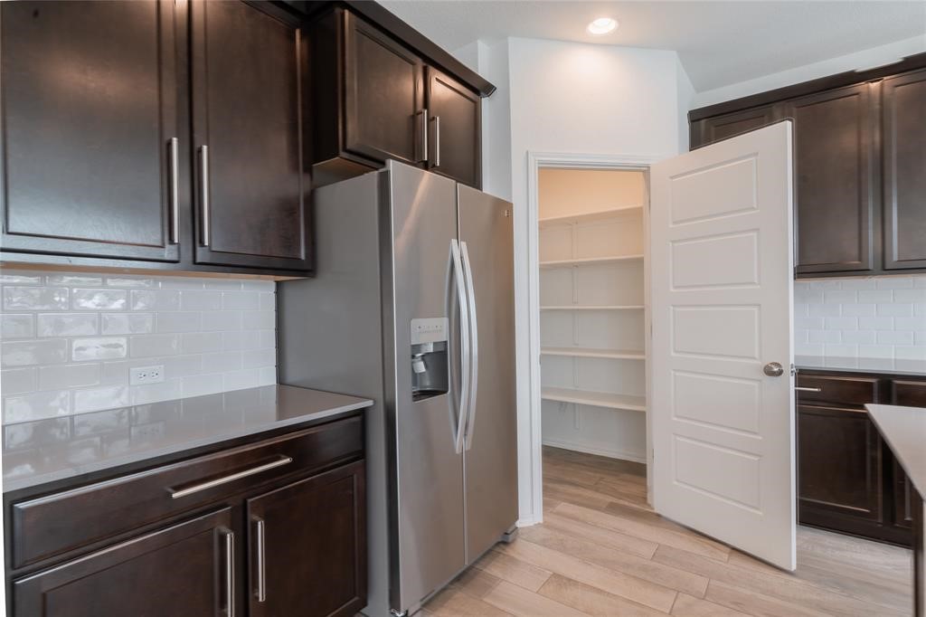 1333 Terrace View Drive Georgetown, TX 78628 - Photo 12 of 35 Ample storage solutions elevate this functional kitchen's design, complete with a convenient pantry.