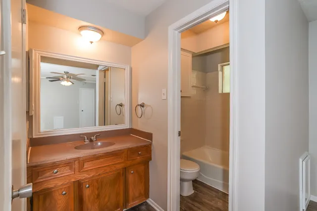 a bathroom with a granite countertop sink toilet and shower