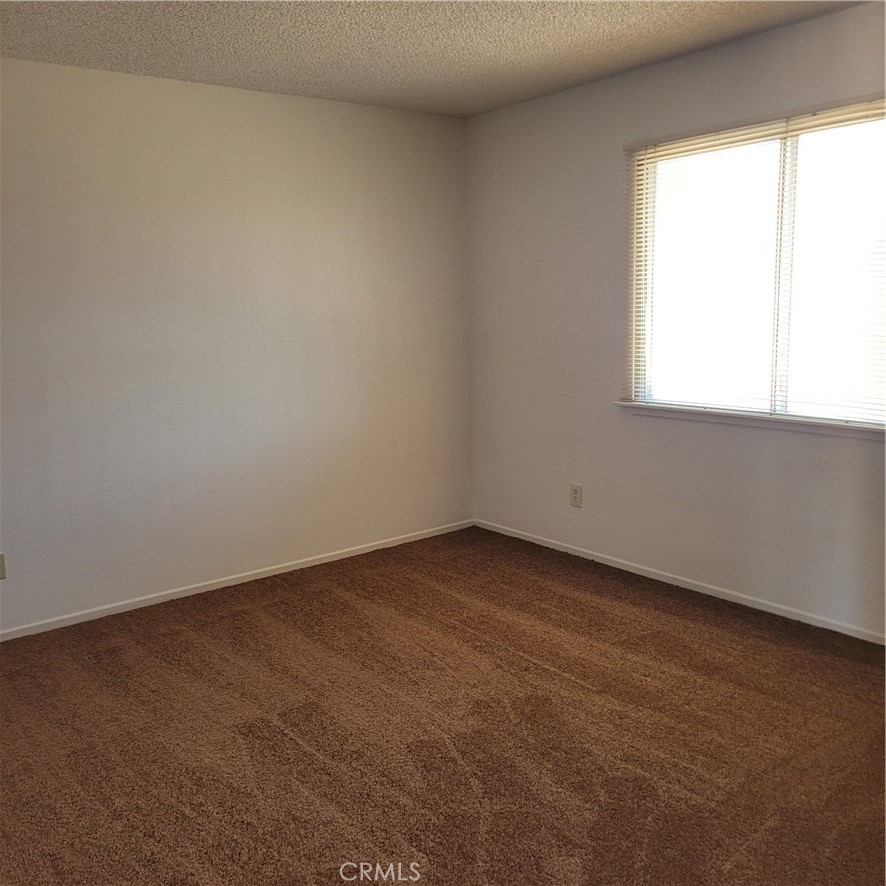 14966 Ritter Street, Unit B Victorville, CA 92394 - Photo 3 of 4 an empty room with a window