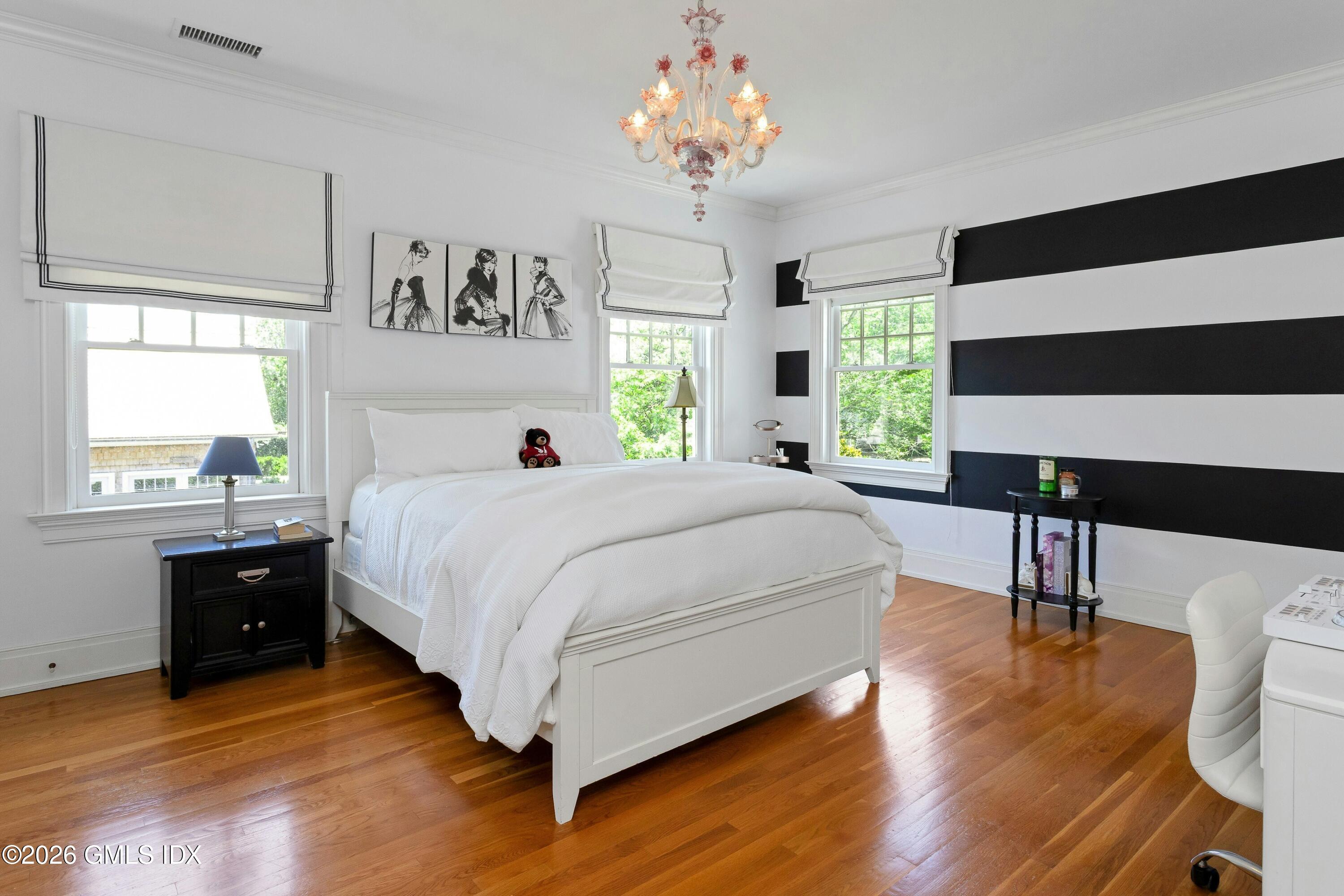 200 Shore Road Old Greenwich, CT 06870 - Photo 17 of 34 a spacious bedroom with a bed and a table in it