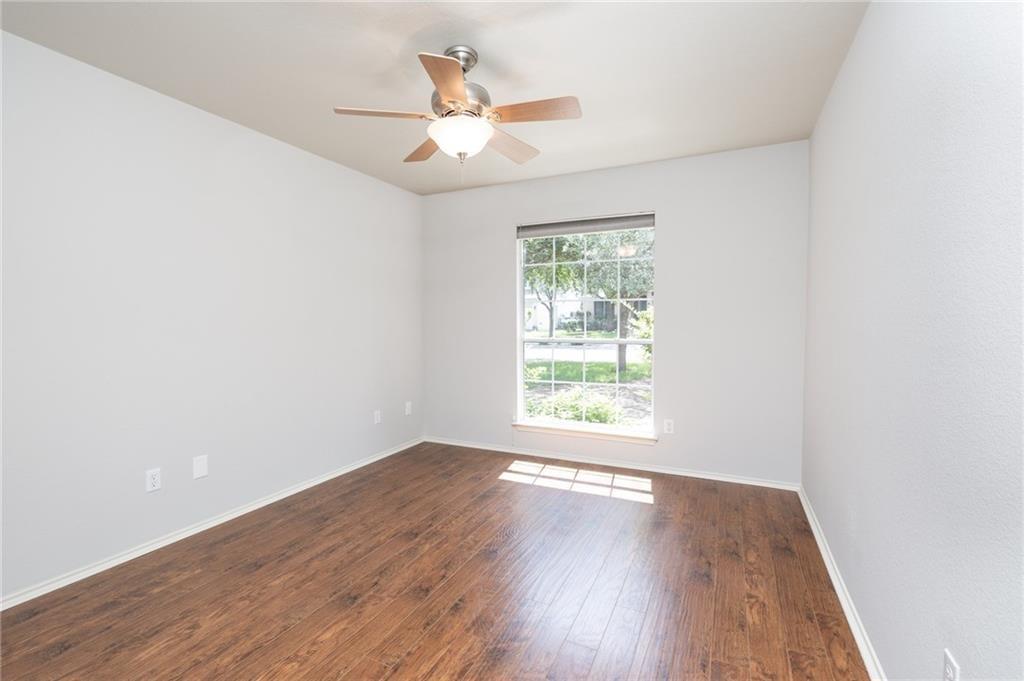 4526 Corran Ferry Loop Austin, TX 78749 - Photo 23 of 25 Rich wood-inspired floors and a large picture window anchor this versatile living space.