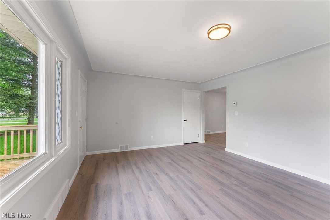 962 Keefer Road Girard, OH 44420 - Photo 4 of 31 Spare room featuring plenty of natural light and hardwood / wood-style flooring