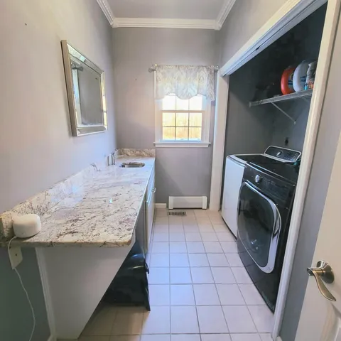 a bathroom with a sink a washer and dryer