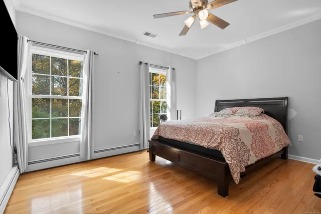 a bedroom with a bed and window