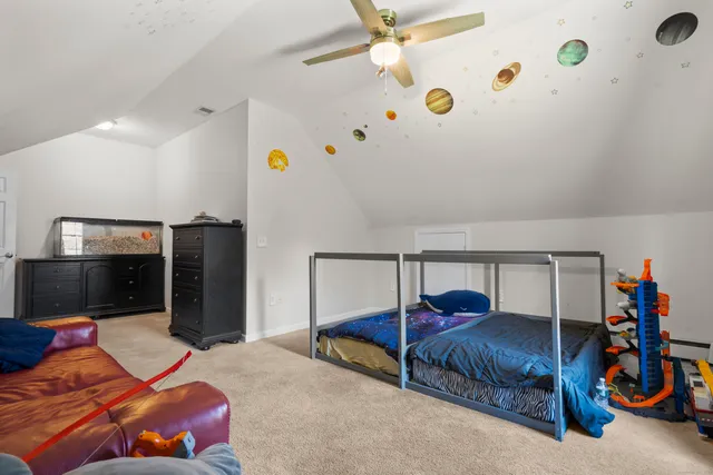 a bedroom with a bed and a tv