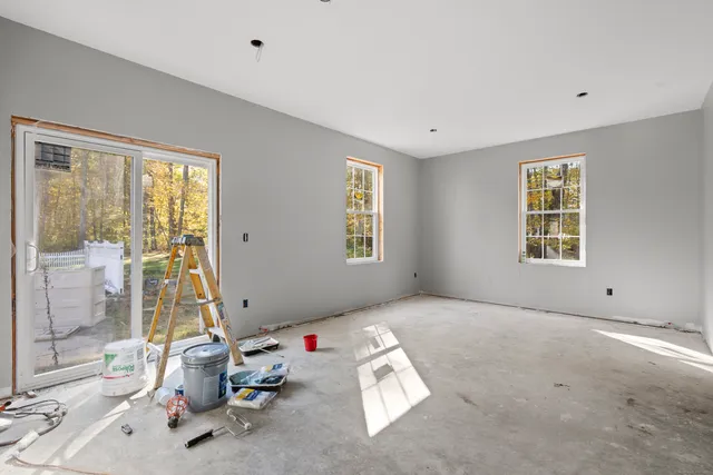 a view of a livingroom with workspace and a window