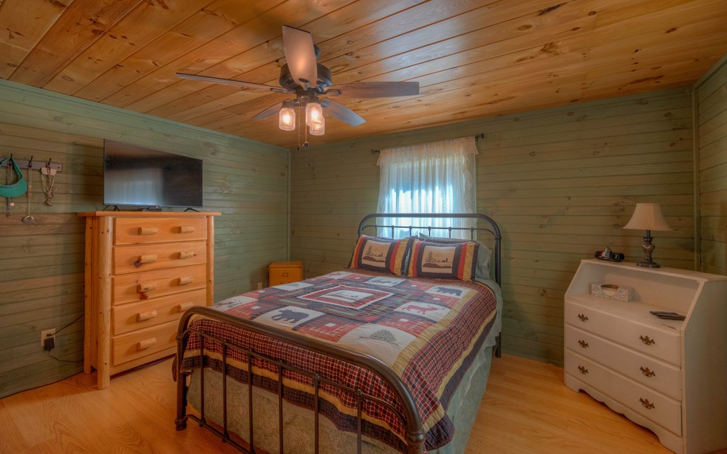 920 McDonald Road Murphy, NC 28906 - Photo 16 of 40 a bedroom with a bed and a ceiling fan