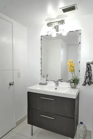 a bathroom with a sink vanity and mirror