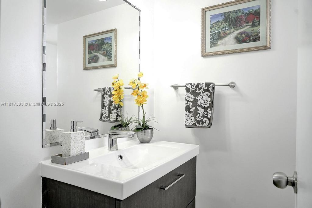 1780 Northeast 191st Street, Unit 4092 Miami, FL 33179 - Photo 15 of 22 a bathroom with a sink and a mirror