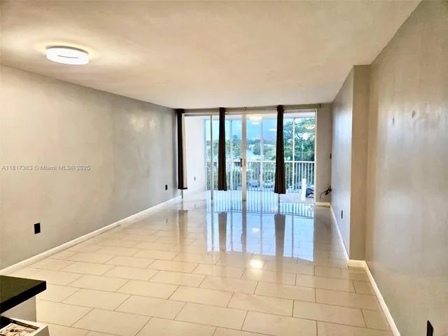 a dining room with chandelier and glass door
