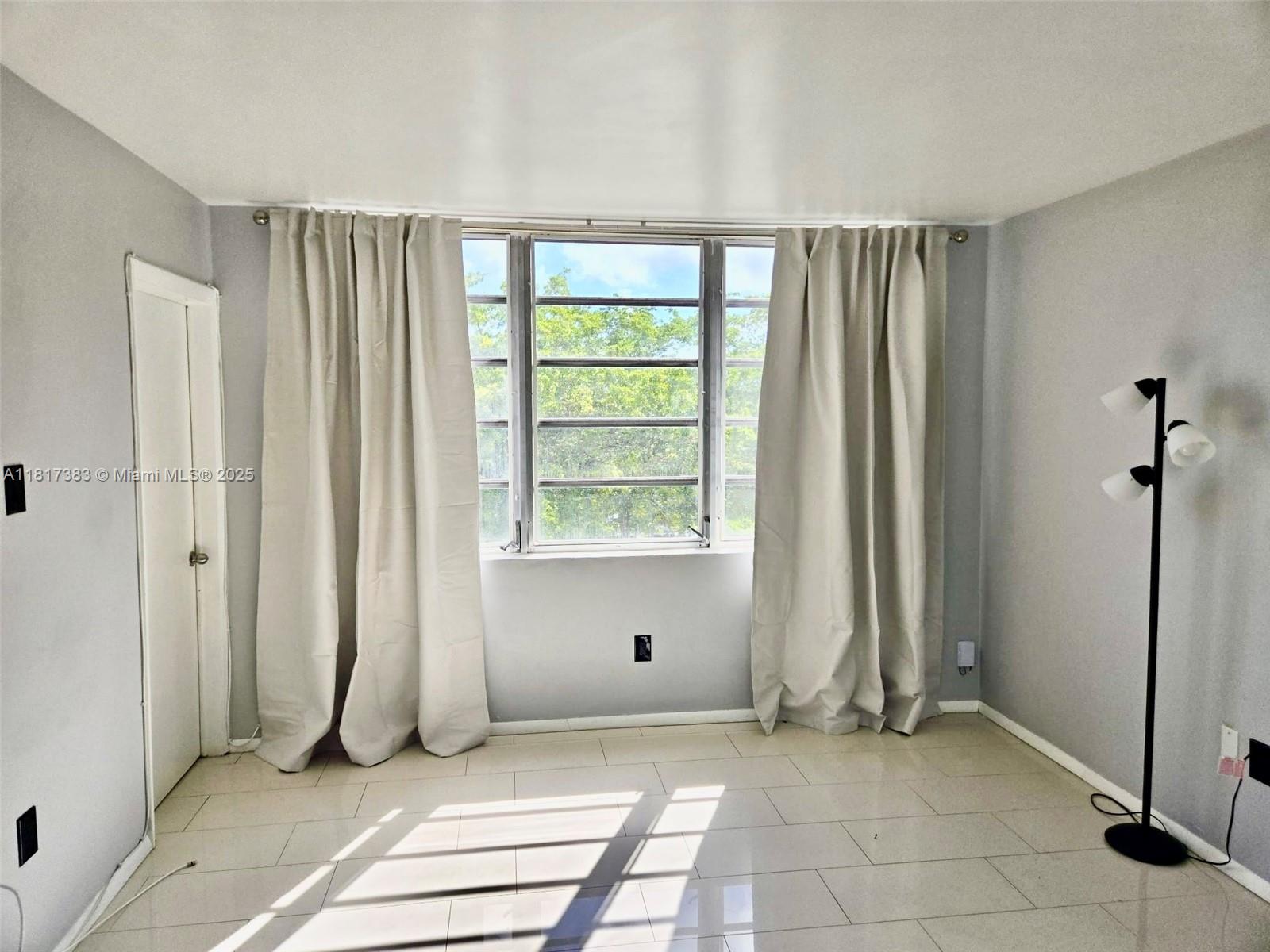 1780 Northeast 191st Street, Unit 4092 Miami, FL 33179 - Photo 4 of 22 a view of a room with a large window