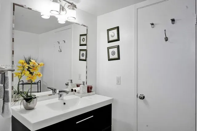 a bathroom with a sink vanity and a mirror