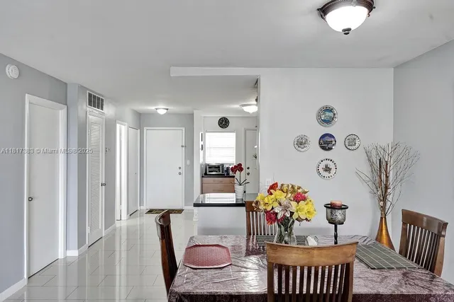 a living room with furniture and flowers