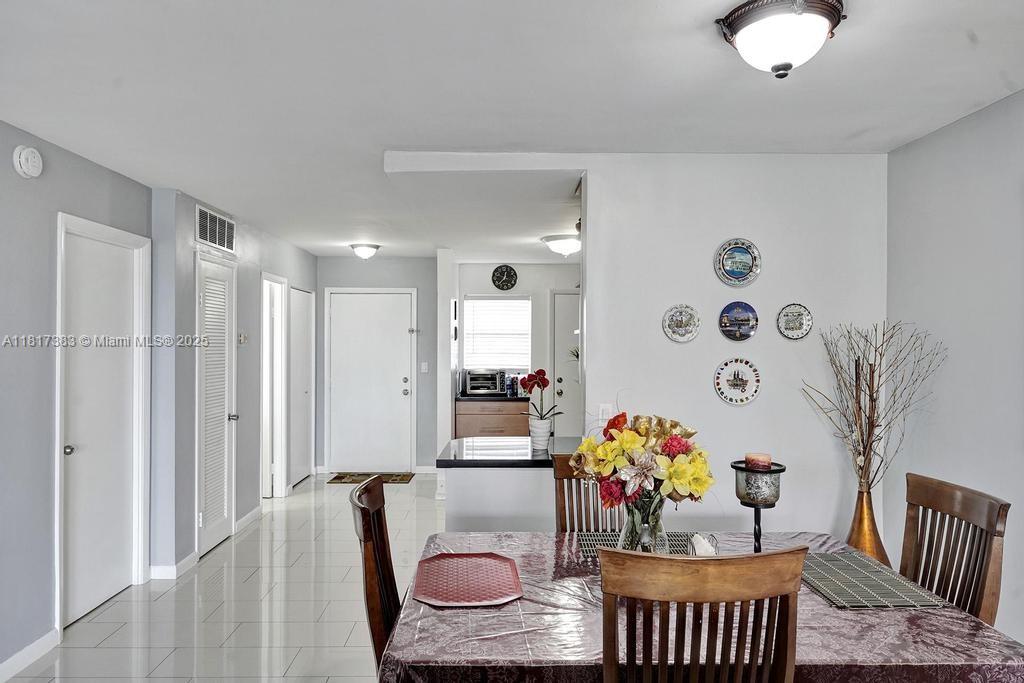1780 Northeast 191st Street, Unit 4092 Miami, FL 33179 - Photo 6 of 22 a living room with furniture and flowers