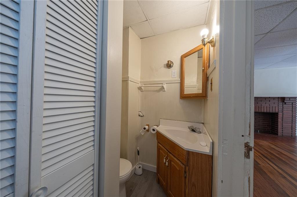 7315 Whipple Street Pittsburgh, PA 15218 - Photo 11 of 24 a bathroom with a sink and mirror with toilet