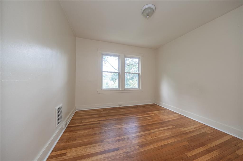 7315 Whipple Street Pittsburgh, PA 15218 - Photo 14 of 24 wooden floor in an empty room with a window