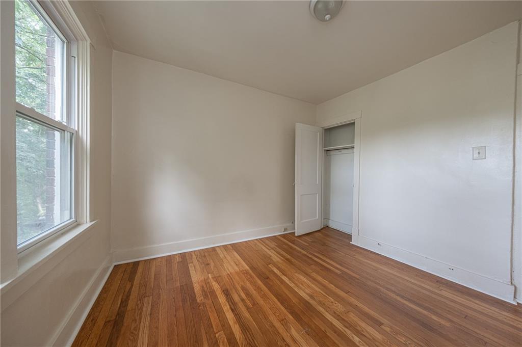 7315 Whipple Street Pittsburgh, PA 15218 - Photo 15 of 24 an empty room with wooden floor and windows