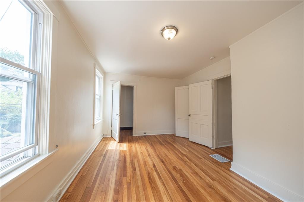 7315 Whipple Street Pittsburgh, PA 15218 - Photo 19 of 24 a view of a room with wooden floor and windows
